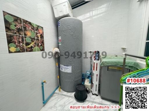 Utility area with water heater and storage items