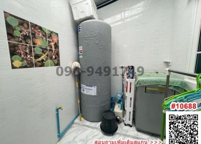 Utility area with water heater and storage items