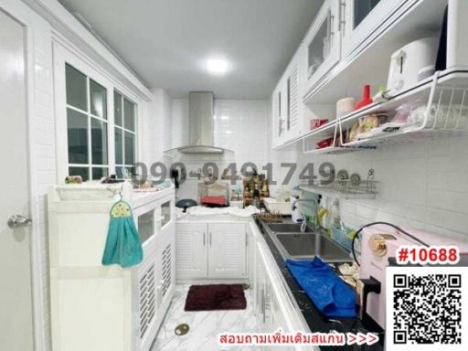 Modern kitchen with white cabinets and ample lighting