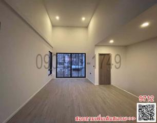 Spacious unfurnished living room with large windows and hardwood flooring