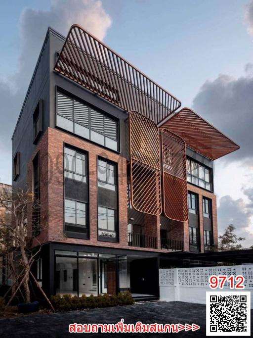 Modern multi-story building exterior with intricate metal facade