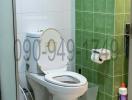 Compact bathroom with toilet and tiled walls