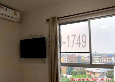 Bedroom with air conditioning unit and a flat screen TV mounted on wall