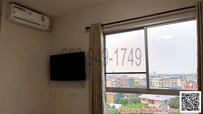 Bedroom with air conditioning unit and a flat screen TV mounted on wall