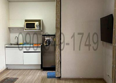 Compact kitchen with modern appliances and wooden flooring