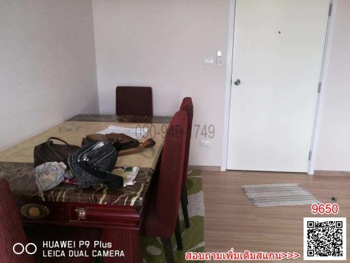 Dining area with wooden table and chairs with personal items on the table