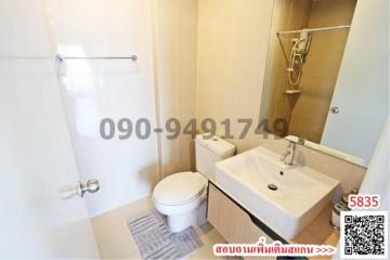 Modern bathroom interior with clear glass shower division, white ceramic toilet, and sink