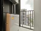 Compact balcony with a city view and washing machine