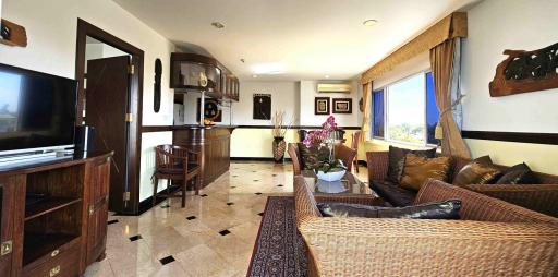 Spacious and well-lit living room with open floor plan connecting to the kitchen