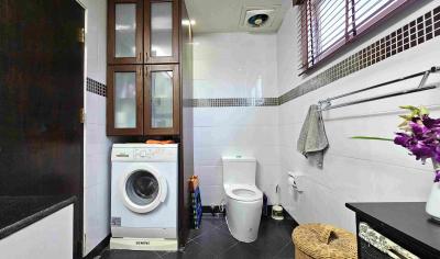 Modern bathroom with white appliances and floral decoration