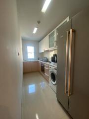 Modern kitchen with stainless steel appliances and window