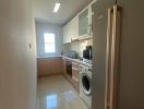 Modern kitchen with stainless steel appliances and window