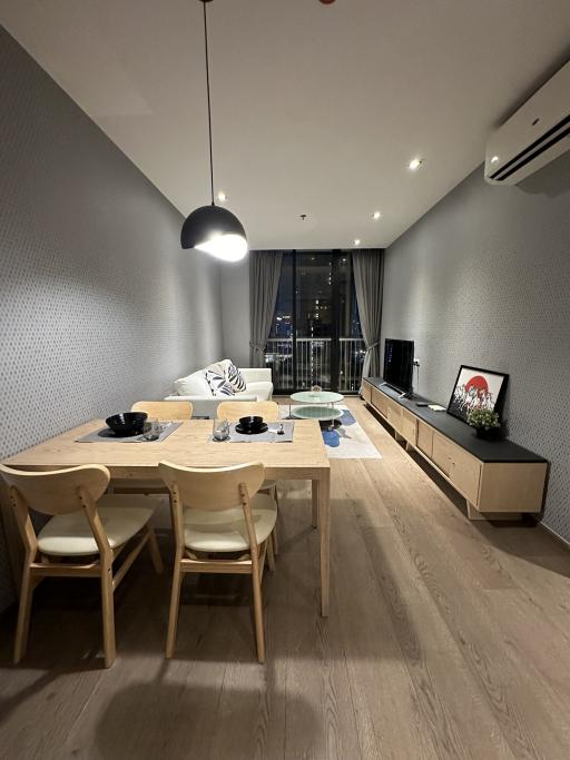 Modern living room with dining area and balcony access