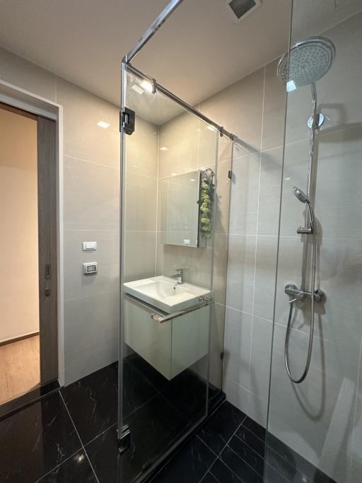 Modern bathroom interior with glass shower and sink
