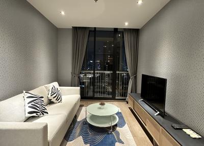 Modern living room with sofa and city view at night