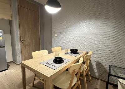 Modern dining area with wooden table and pendant lighting