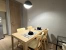 Modern dining area with wooden table and pendant lighting