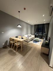 Modern living room with dining area and balcony access