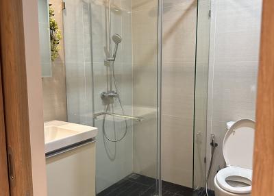 Modern bathroom with glass shower and white fixtures