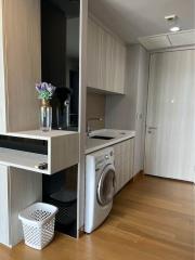 Modern laundry room with washing machine and built-in cabinets