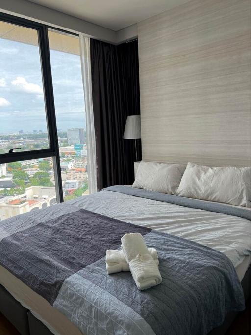 Modern bedroom with city view and ample natural light