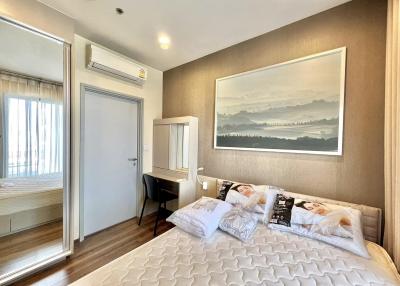 Cozy modern bedroom with queen-sized bed and a large picture window