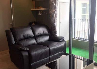 Cozy modern living room with leather sofa and glass coffee table