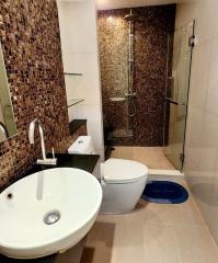 Modern bathroom with mosaic tiles and glass shower enclosure