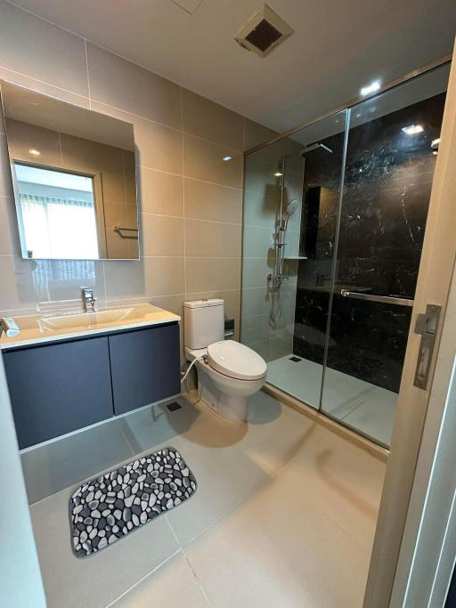 Modern bathroom interior with glass shower and tile flooring