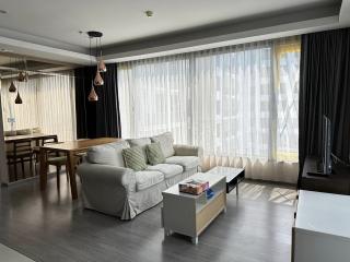 Spacious living room with sofa, coffee table and dining area