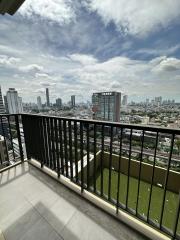 Spacious balcony with city skyline view and safety railing