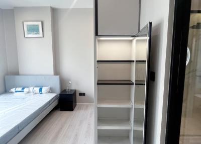 Modern bedroom with queen-size bed and built-in wardrobe