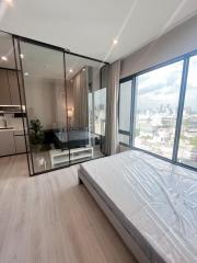 Modern bedroom with large windows and city view