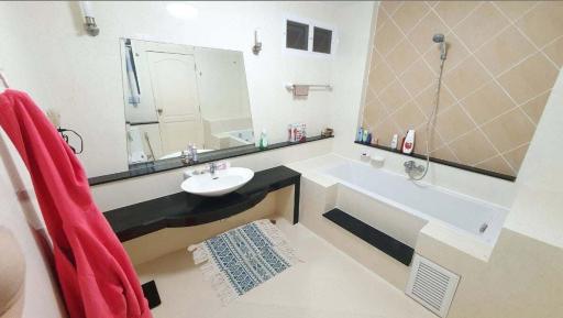 modern spacious bathroom with white fixtures and a bathtub