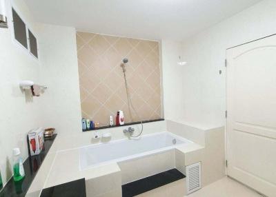 Spacious clean bathroom with tub and modern fixtures
