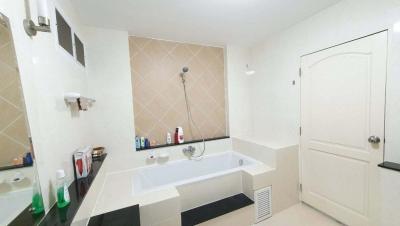 Spacious clean bathroom with tub and modern fixtures