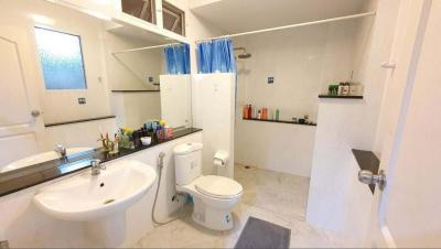 Spacious bathroom with modern amenities and clean white decor