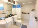 Spacious bathroom with modern amenities and clean white decor