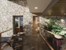 Modern house entrance with natural stone wall and wooden ceiling