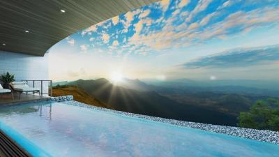 Luxurious infinity pool with panoramic mountain view at sunset
