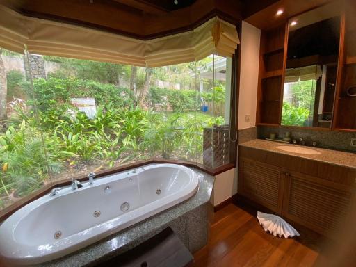 Luxury bathroom with a view of lush greenery