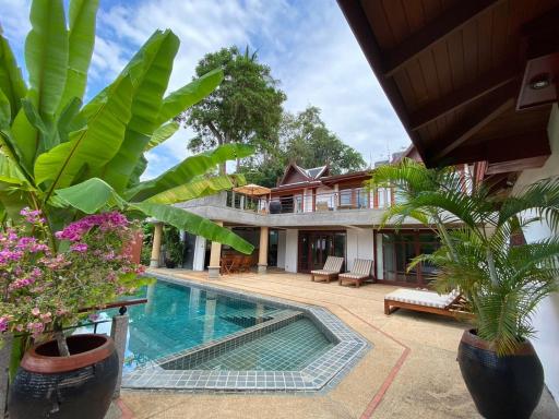 Luxurious house exterior with swimming pool and tropical plants