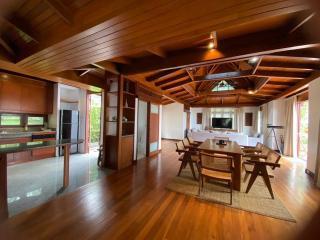 Spacious living room with wooden interiors and dining area