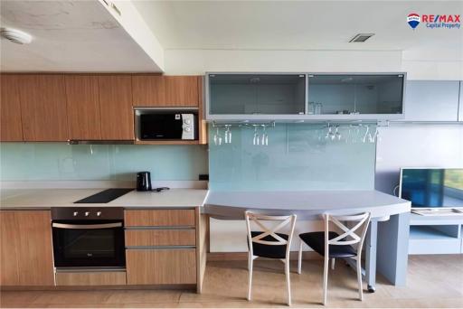 Modern kitchen with integrated appliances and dining area