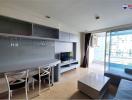 Modern living room with natural light and balcony access