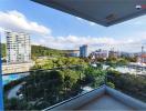 Spacious balcony with a scenic city view and clear blue sky