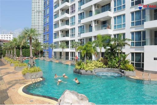 Residents enjoying the communal outdoor swimming pool in a modern apartment complex