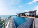 Luxurious rooftop infinity pool with ocean view in modern residential building