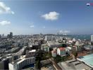 Panoramic city view from a high-rise building showcasing urban landscape and coastline