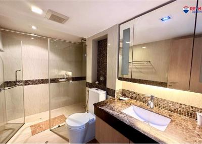 Modern bathroom with glass shower and dual sinks